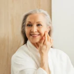 Mature woman touching her face
