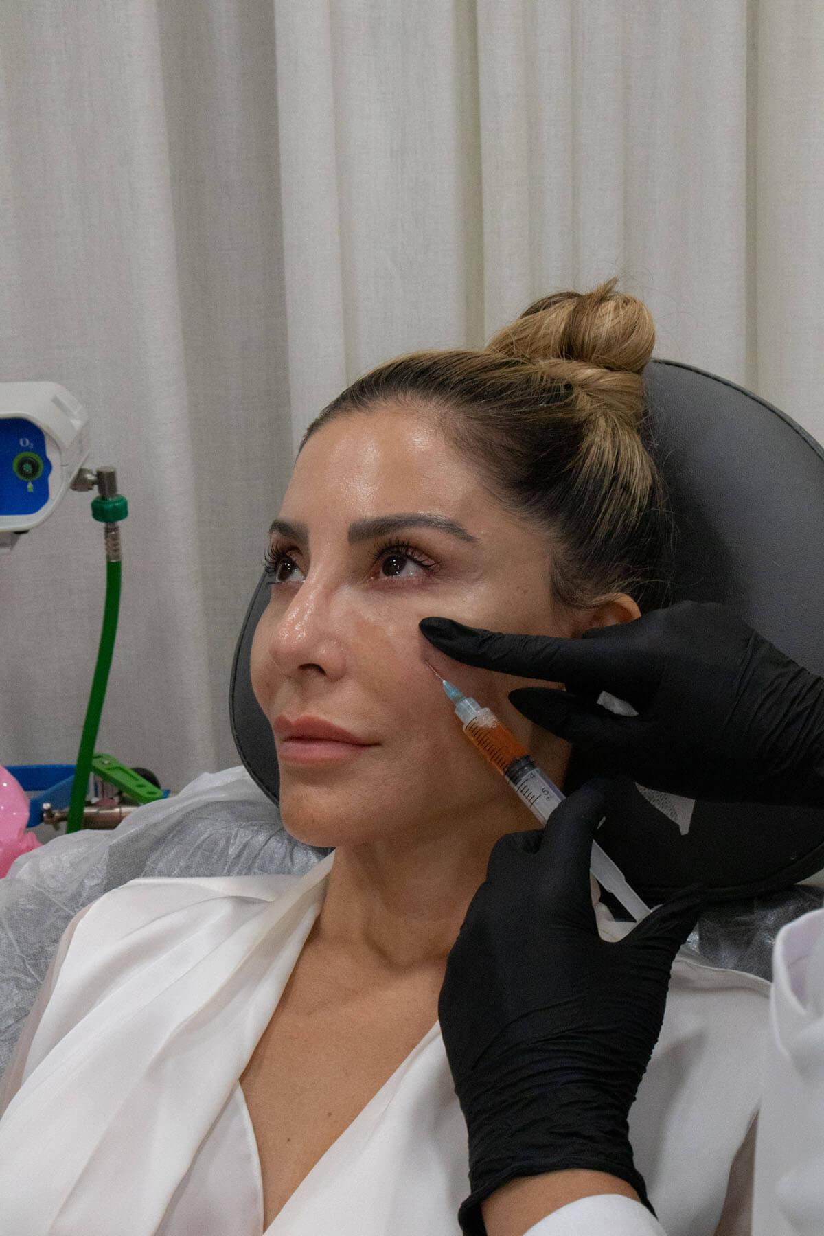 Woman getting face injection in her cheek
