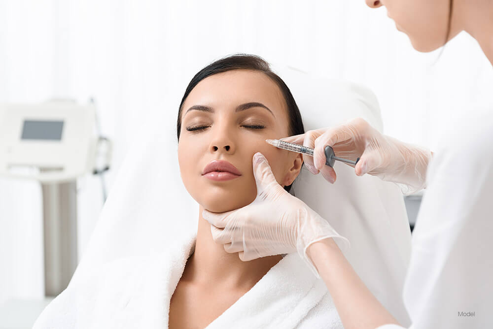 Woman getting a facial injection